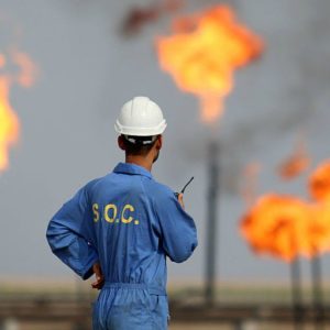 Oil worker in front of oil fields