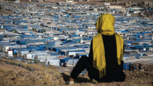 a-woman-looks-out-over-the-kawergosk-refugee-camp