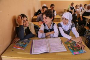 On 01 November, Sjud, 11 (centre), is back in class in Ramadi three days after returning home from a camp in Sulaymaniyah. UNICEF supported the rehabilitation of this school after it was damaged by conflict. There are four different schools using the building to hold classes, operating in four shifts, in order to get 2,020 children back to learning. 3.5 million school-aged Iraqi children are missing out on education, which means they are at increased risk of early marriage, child labour and recruitment into armed groups. One in every five schools is out use due to conflict. UNICEF is working to get children back to learning across Iraq, including in Anbar, a Governorate that has been particularly hard hit by conflict and high levels of internal displacement. In Anbar UNICEF and partners are refurbishing and extending school structures; providing desks, textbooks and school bags; and helping children to catch up on lost school time, as well as to reintegrate into the education system. From January to September 2016 across Iraq UNICEF helped get more than 116,000 out-of-school children back into classrooms, installed pre-fab school structures benefitting 42,000 displaced children, and distributed school supplies and learning materials to more than 280,000 children. UNICEF also trained more than 2,350 education staff, helped 383 schools improve their governance practices, mainstreamed life skills education in 439 schools, and helped reopen schools in previously inaccessible areas like Anbar.